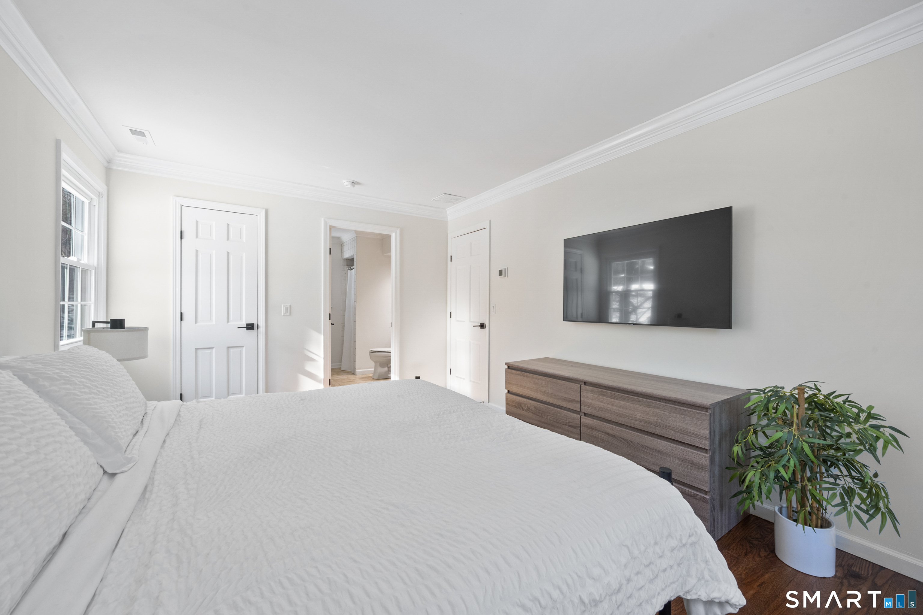 6 Buckboard Lane Fairfield, CT 06824 - Photo 12 of 23 a bedroom with a bed and a potted plant