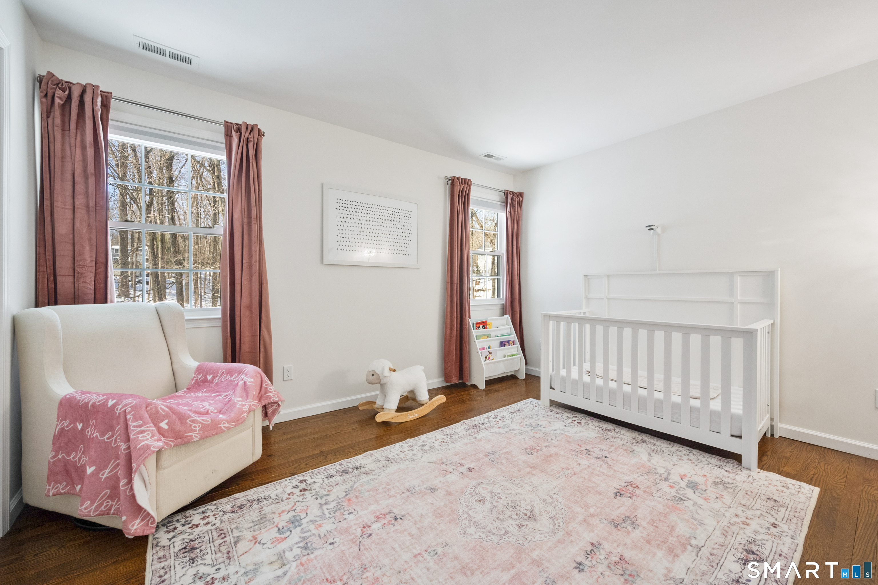 6 Buckboard Lane Fairfield, CT 06824 - Photo 16 of 23 a bedroom with a bed and wooden floor