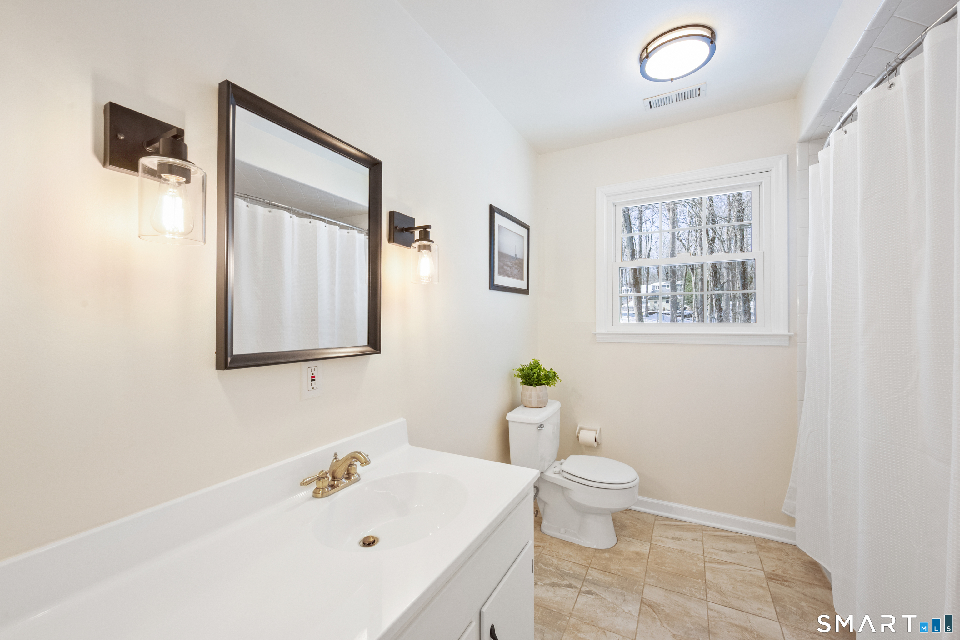 6 Buckboard Lane Fairfield, CT 06824 - Photo 17 of 23 a bathroom with a sink a toilet and shower curtain