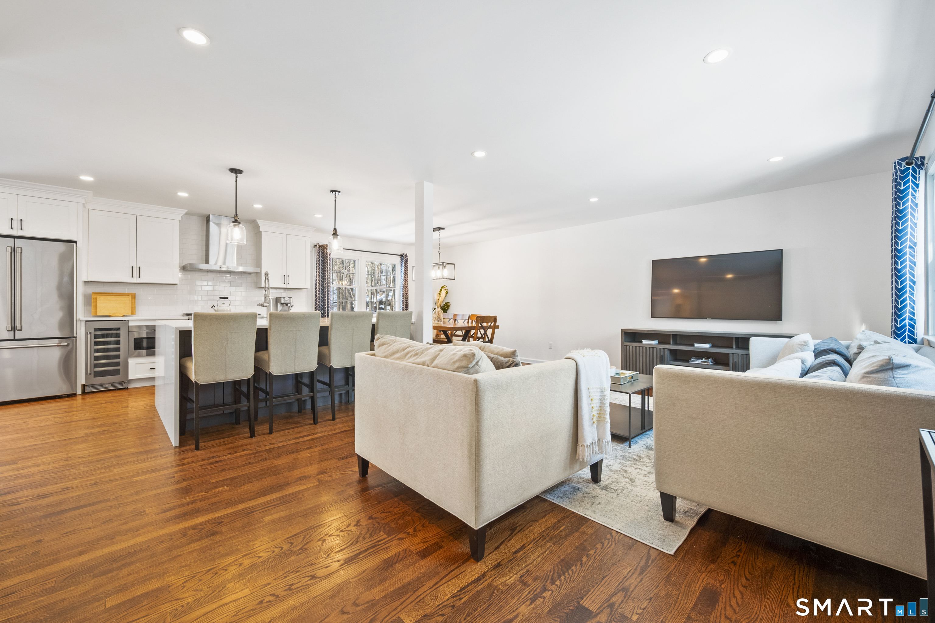 6 Buckboard Lane Fairfield, CT 06824 - Photo 2 of 23 a living room with furniture and a kitchen view with wooden floor
