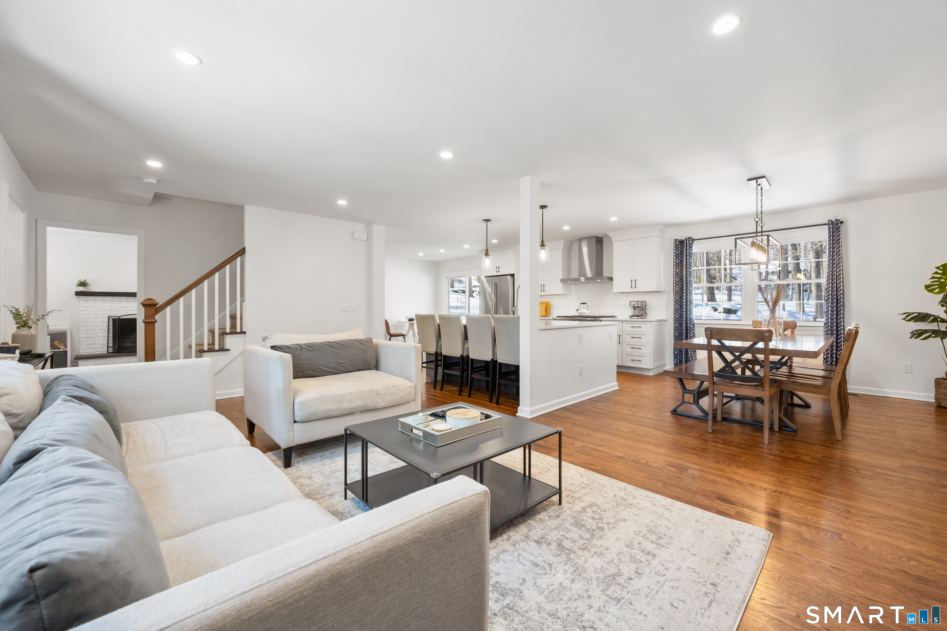6 Buckboard Lane Fairfield, CT 06824 - Photo 4 of 23 a living room with furniture and a dining table with kitchen view