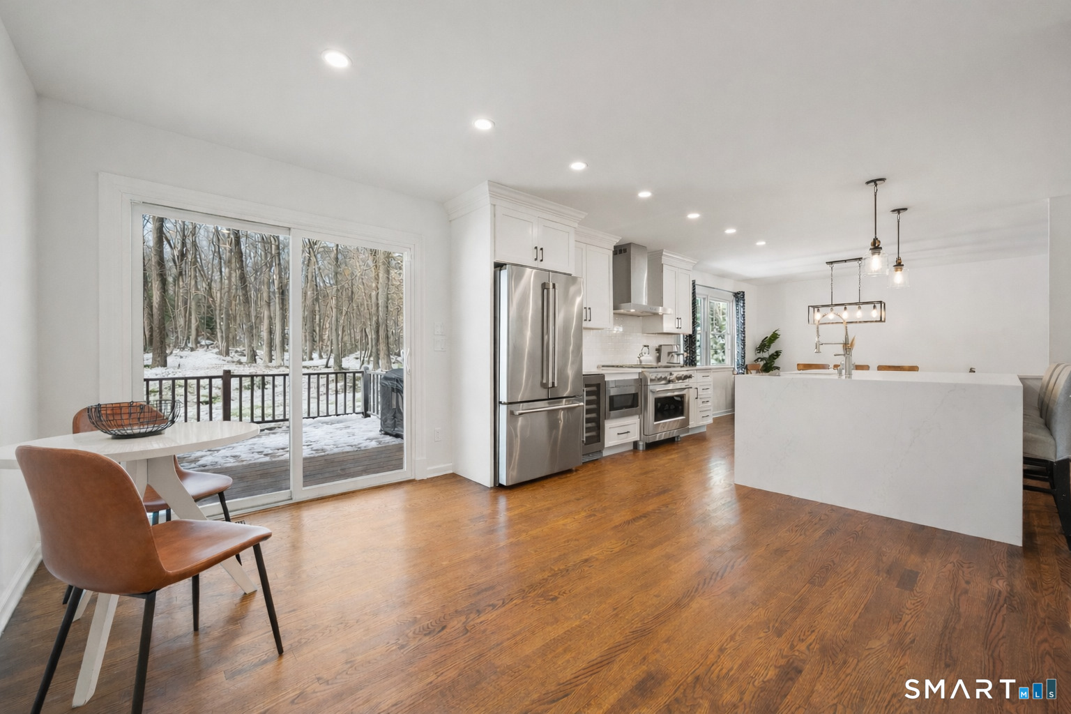 6 Buckboard Lane Fairfield, CT 06824 - Photo 5 of 23 a kitchen with stainless steel appliances wooden floor and a refrigerator