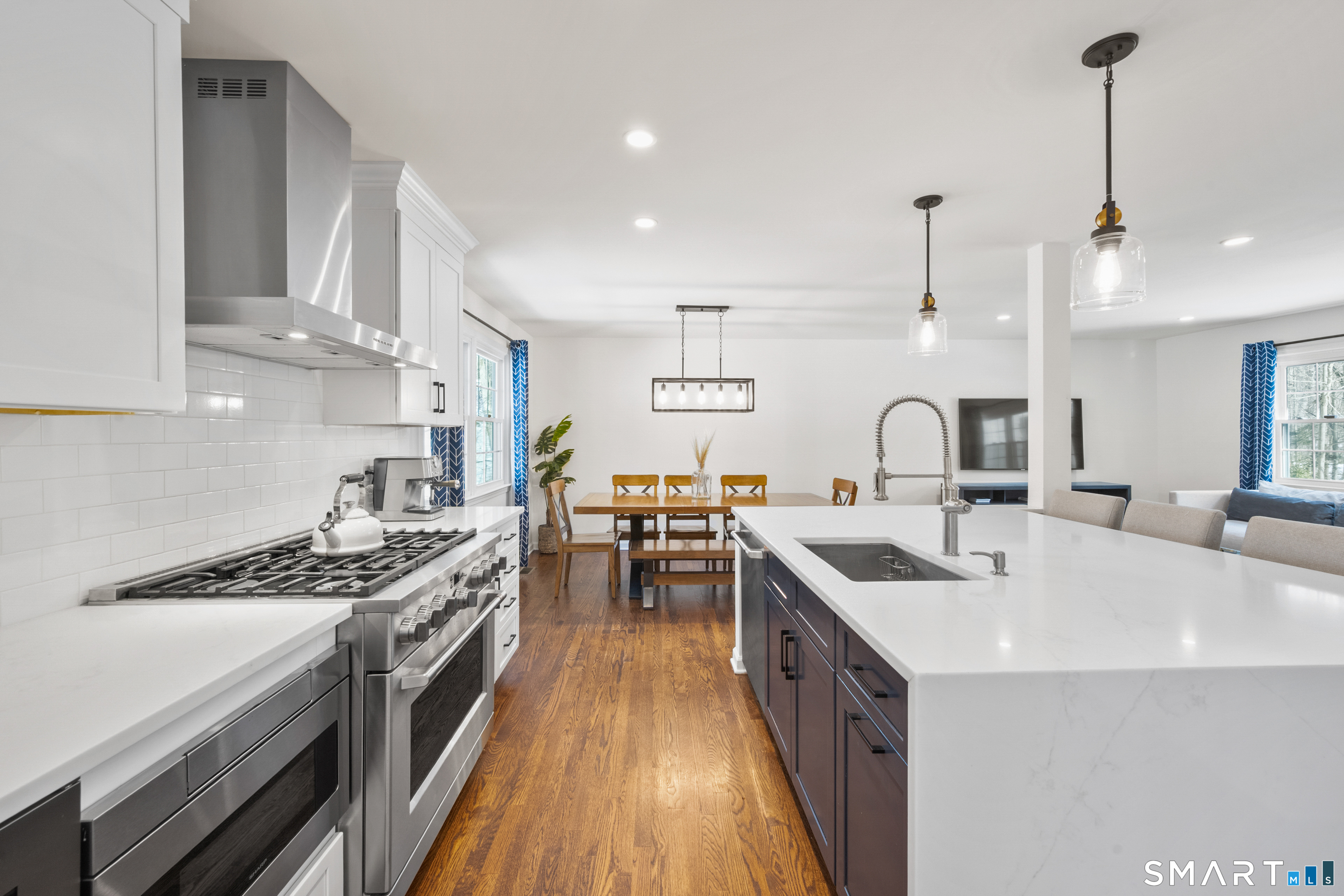6 Buckboard Lane Fairfield, CT 06824 - Photo 8 of 23 a kitchen with stainless steel appliances a sink stove and cabinets