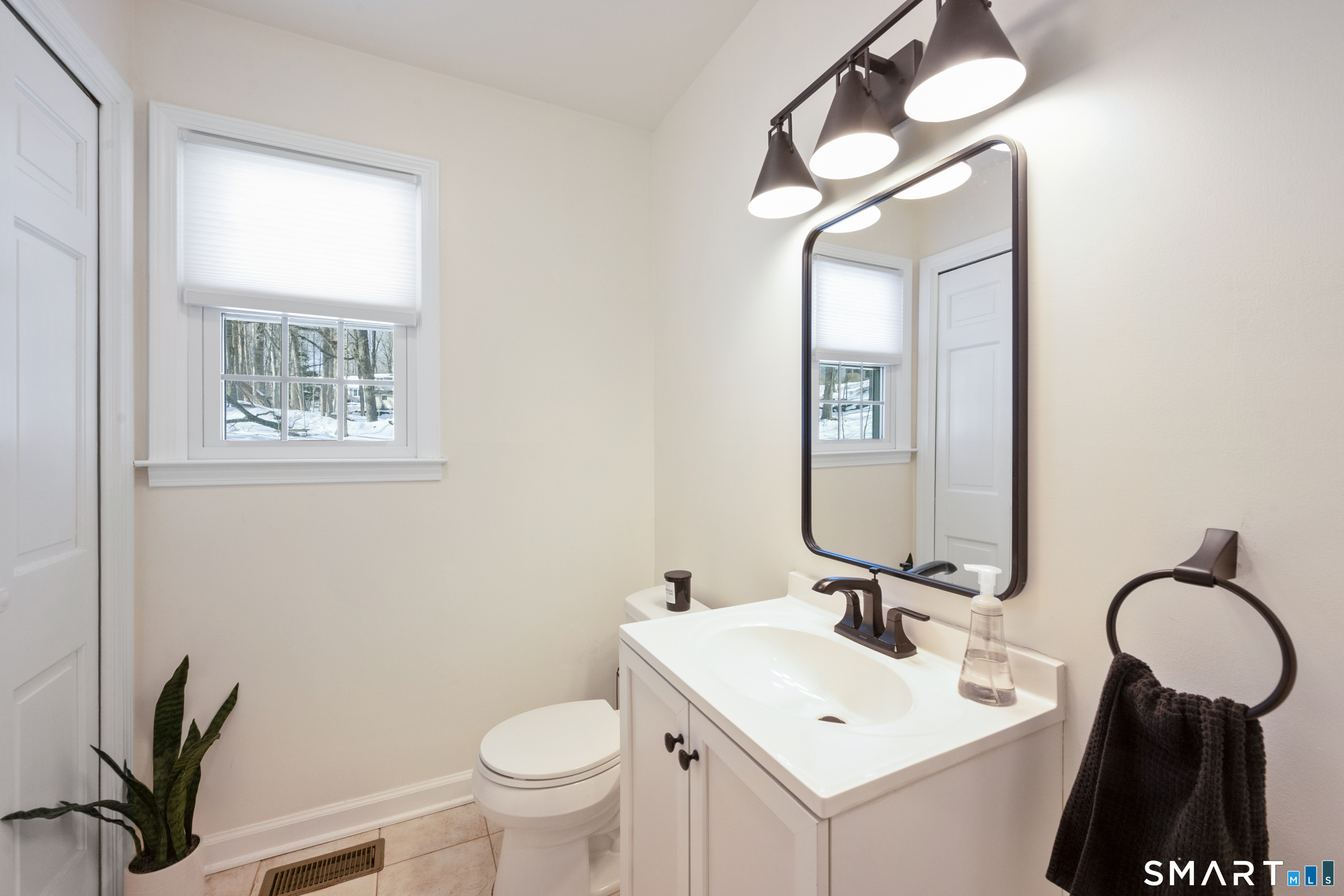 6 Buckboard Lane Fairfield, CT 06824 - Photo 10 of 23 a bathroom with a toilet sink and mirror