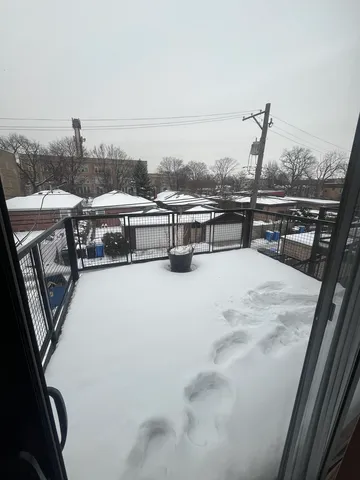 a view of a balcony with wooden floor and city view