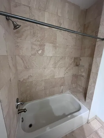 a bath tub sitting next to a shower