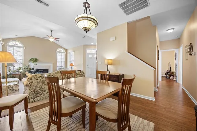 a view of a dining room with furniture wooden floor and chandelier
