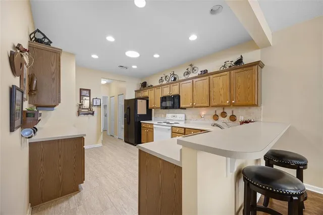 a kitchen with stainless steel appliances a sink stove and refrigerator