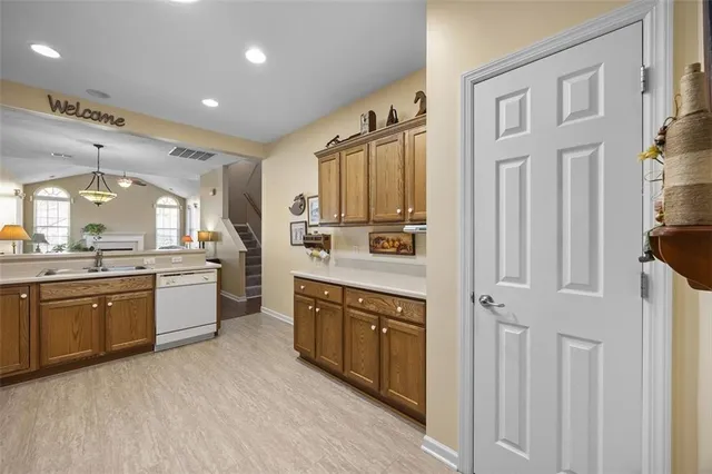 a large kitchen with stainless steel appliances granite countertop a stove a sink dishwasher and a refrigerator