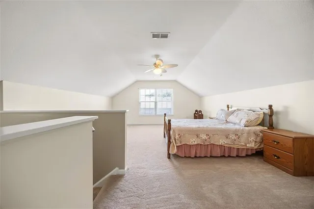 a spacious bedroom with a bed and a window