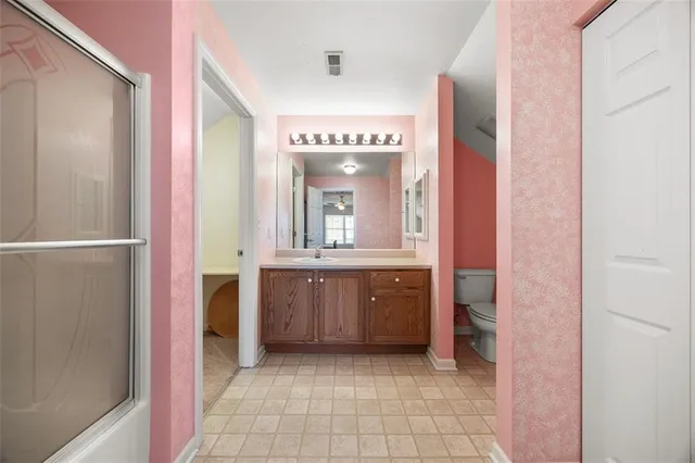 a bathroom with a granite countertop sink mirror and a bathtub
