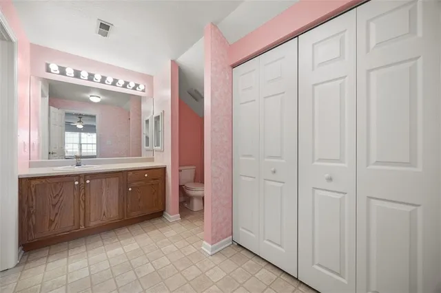 a spacious bathroom with a double vanity sink a mirror and a bathtub