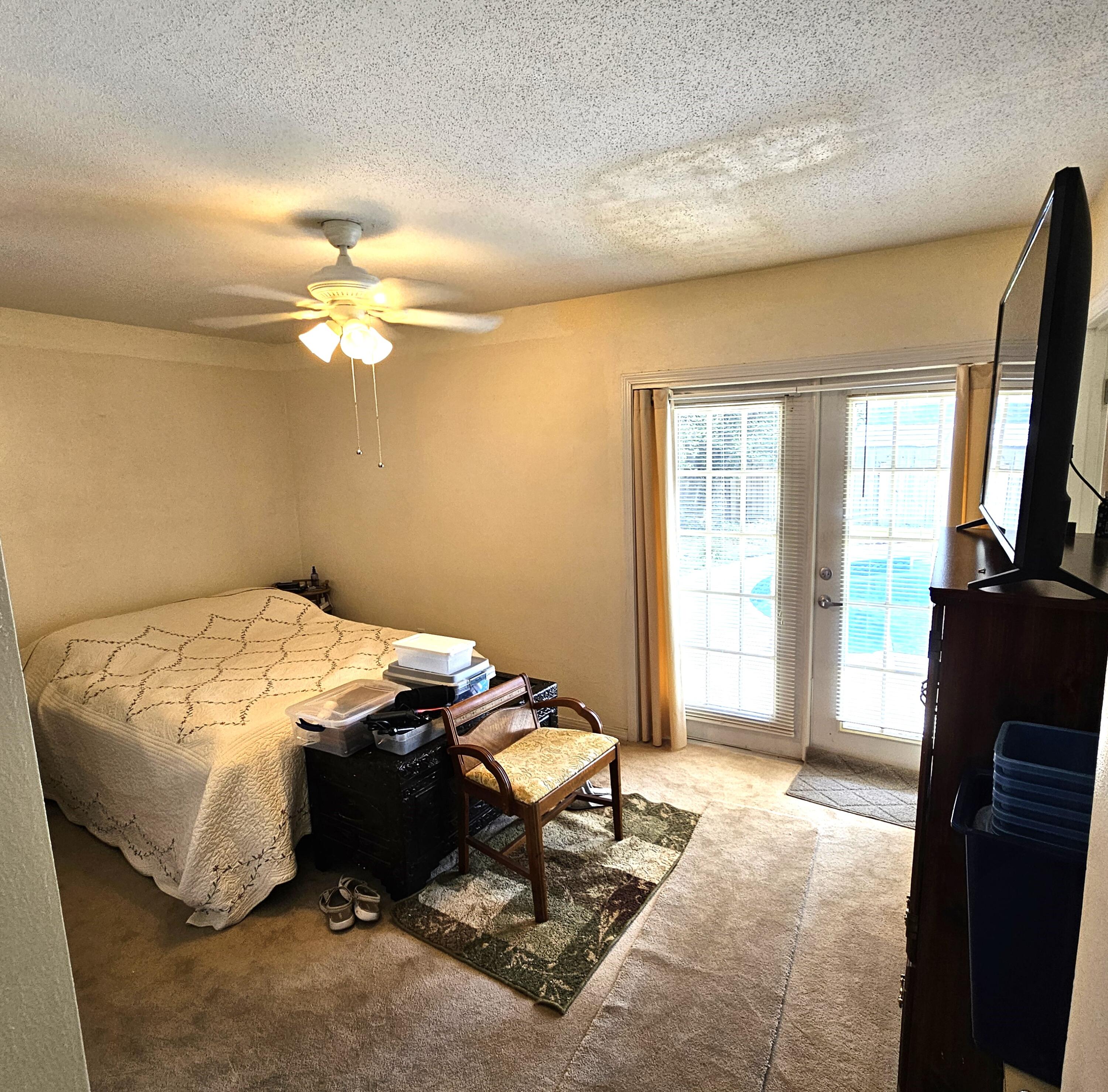 13 10th Street Shalimar, FL 32579 - Photo 12 of 17 a bedroom with a bed and a chandelier