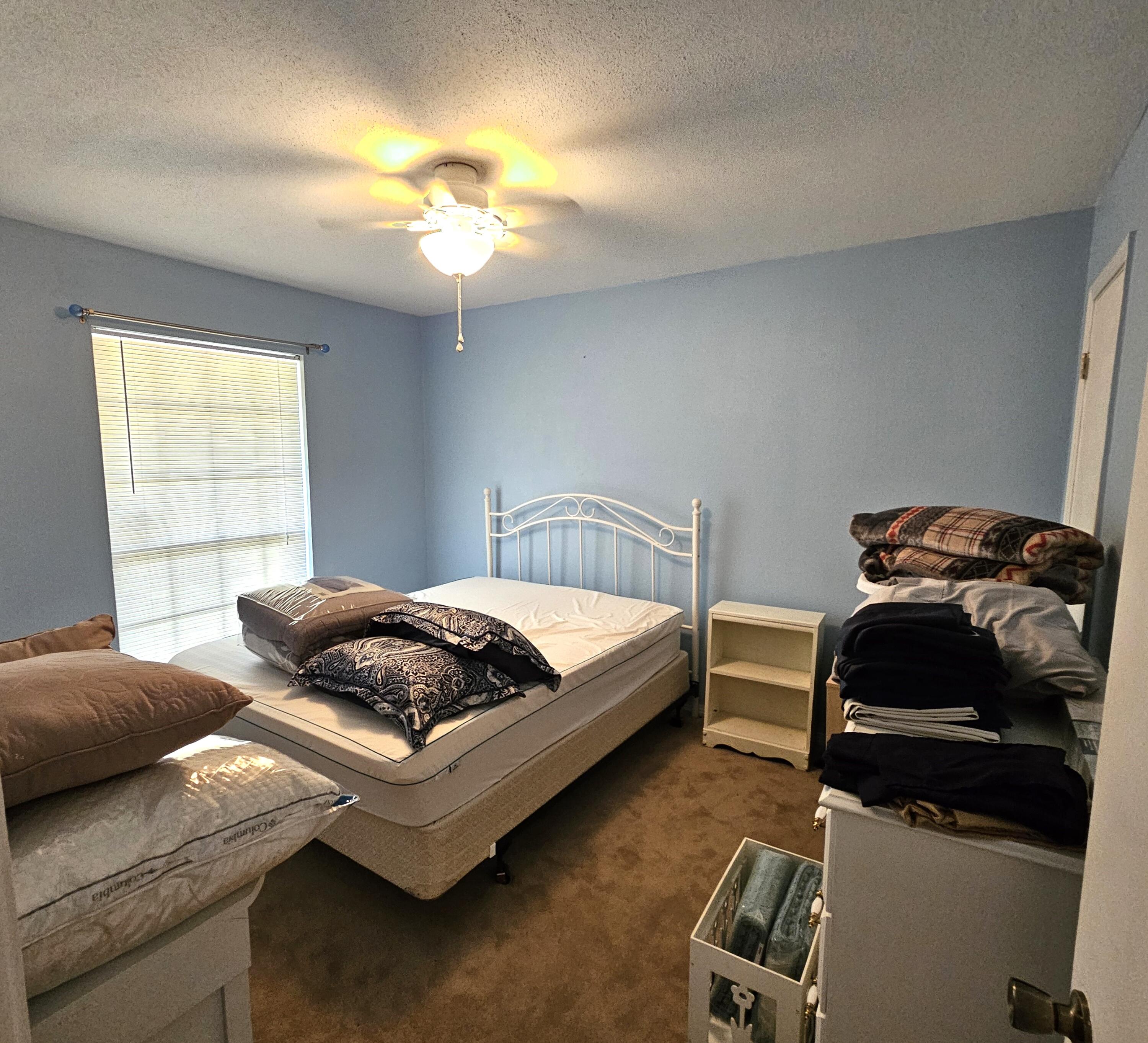 13 10th Street Shalimar, FL 32579 - Photo 15 of 17 a bedroom with a bed and a window