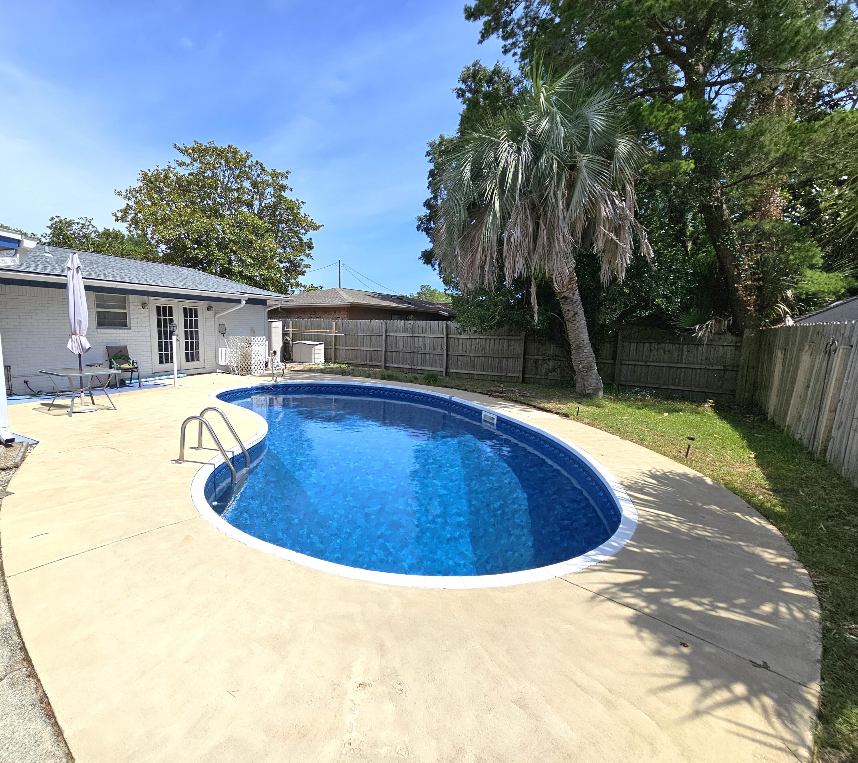 13 10th Street Shalimar, FL 32579 - Photo 17 of 17 a view of a swimming pool with a patio