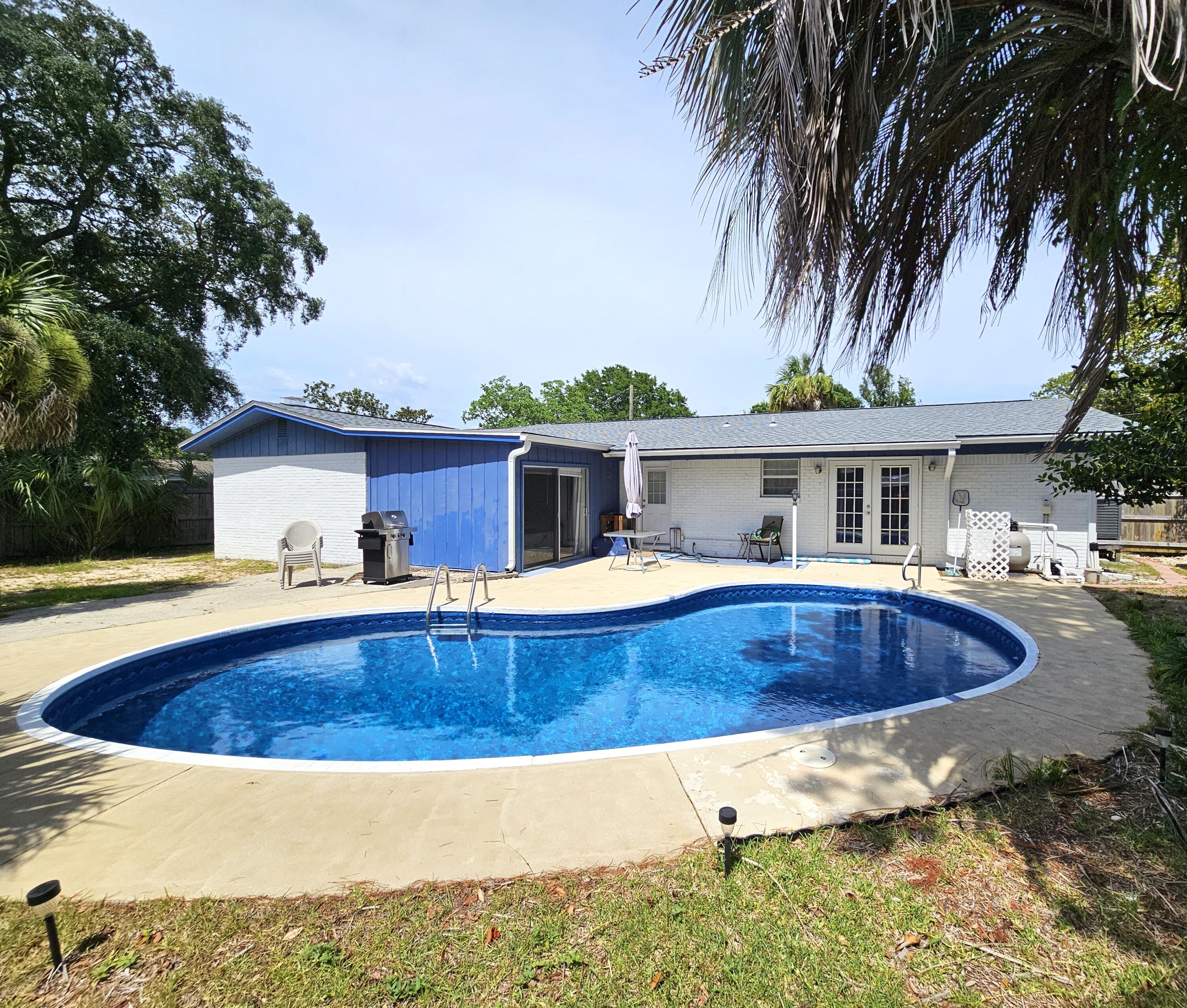 13 10th Street Shalimar, FL 32579 - Photo 2 of 17 a view of house with swimming pool and a yard
