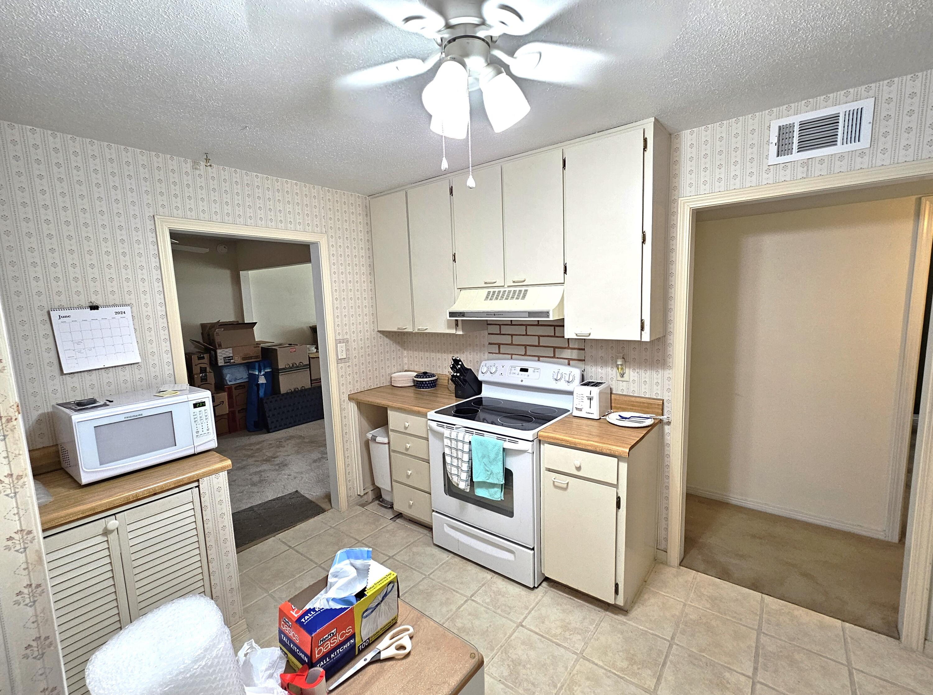 13 10th Street Shalimar, FL 32579 - Photo 6 of 17 a kitchen with a stove a sink and a refrigerator
