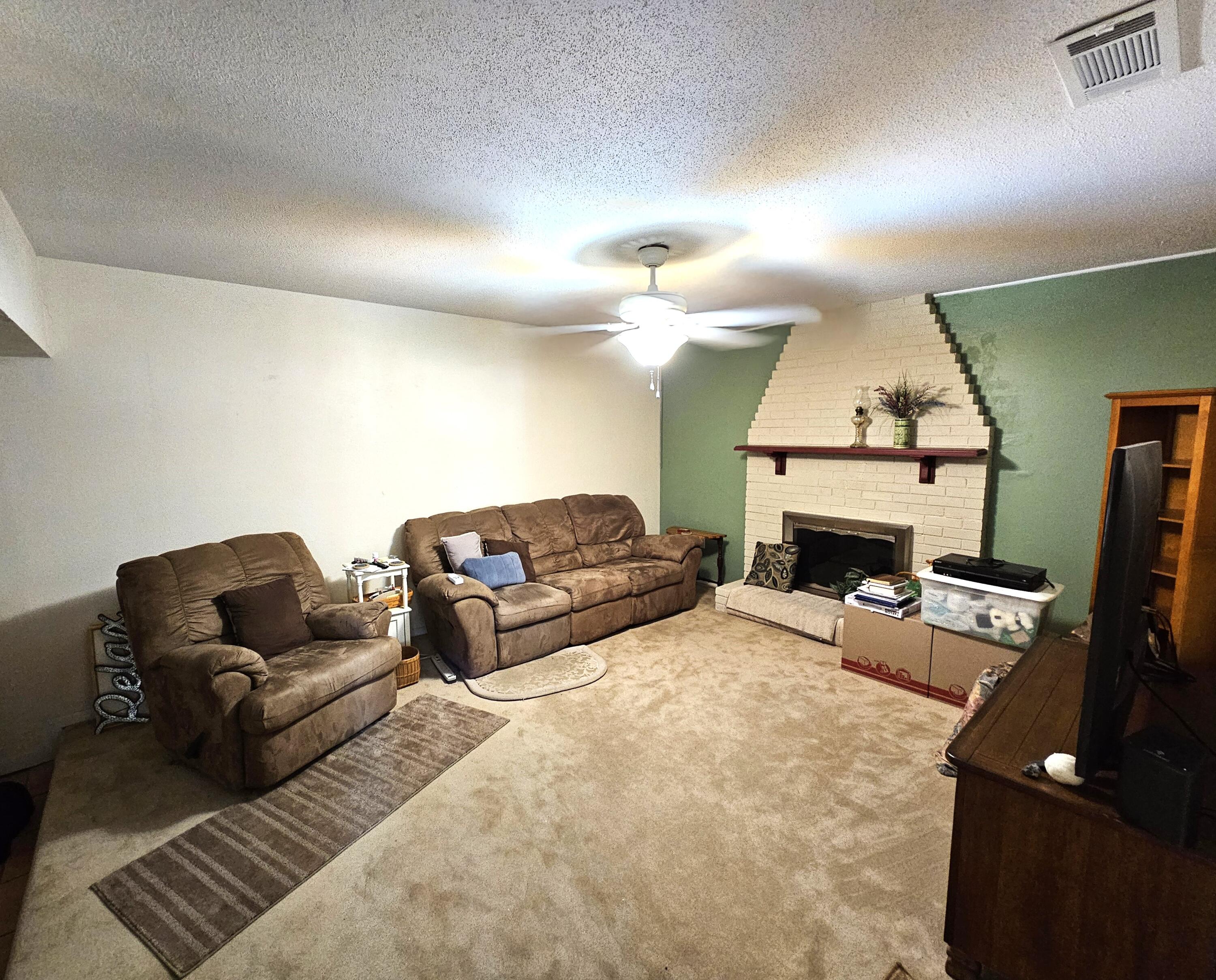 13 10th Street Shalimar, FL 32579 - Photo 8 of 17 a living room with furniture a fireplace and a flat screen tv