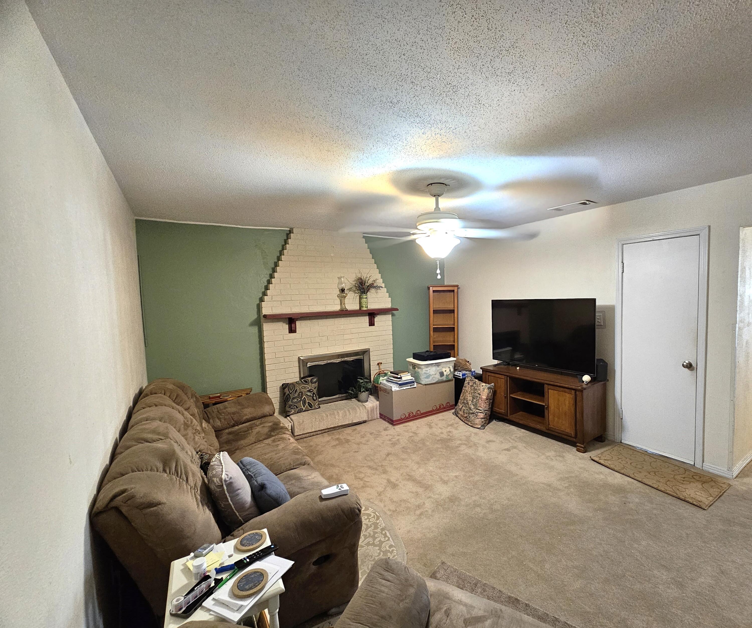 13 10th Street Shalimar, FL 32579 - Photo 9 of 17 a living room with furniture a fireplace and a flat screen tv