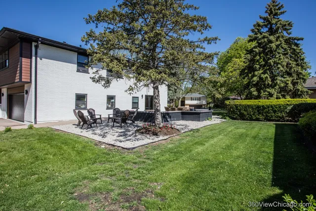 a view of a backyard with sitting area