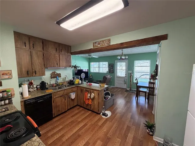 a kitchen with sink refrigerator and cabinets