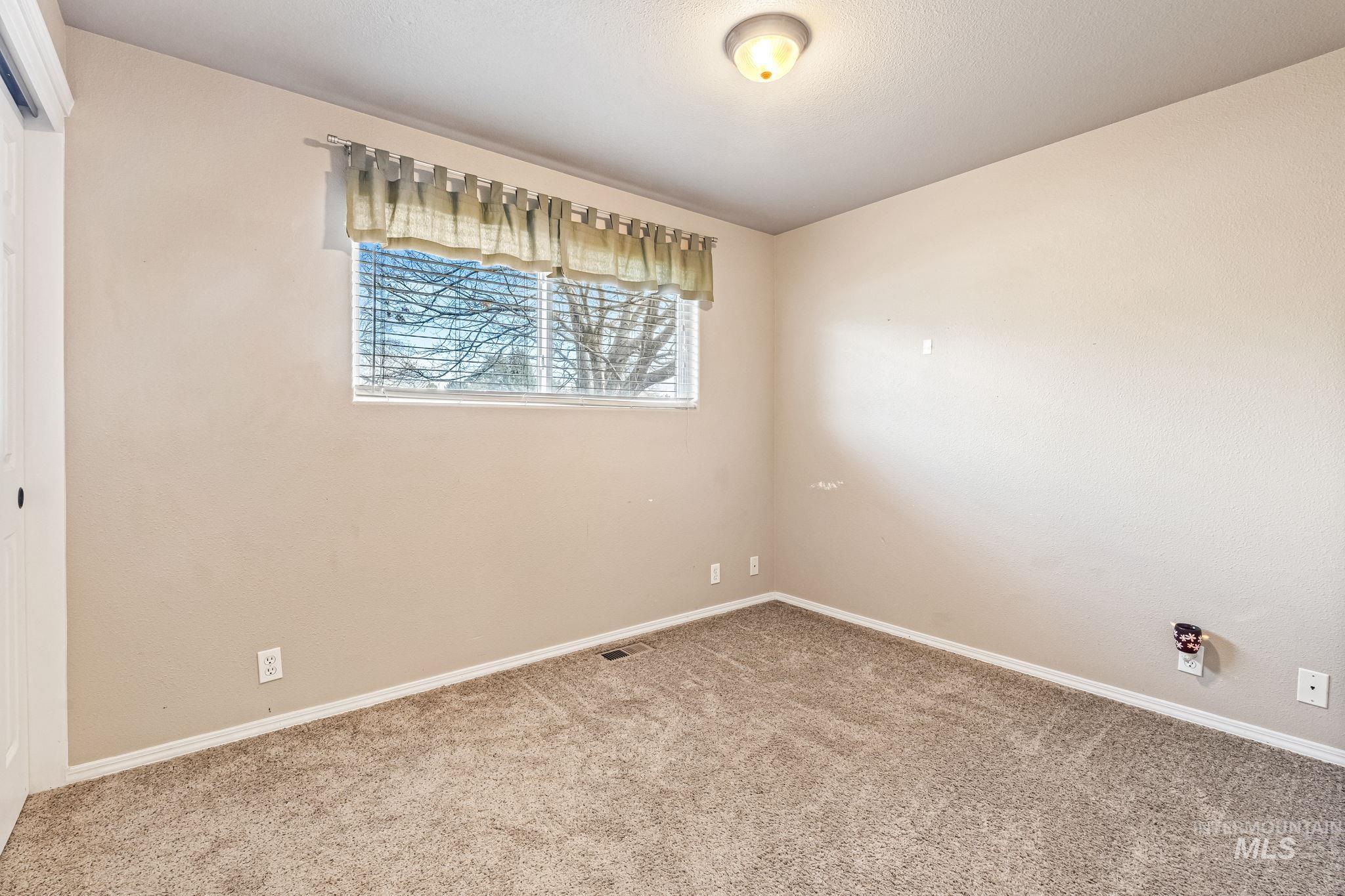 7650 West Colt Drive Boise, ID 83709 - Photo 14 of 30 Spare room with carpet flooring and baseboards