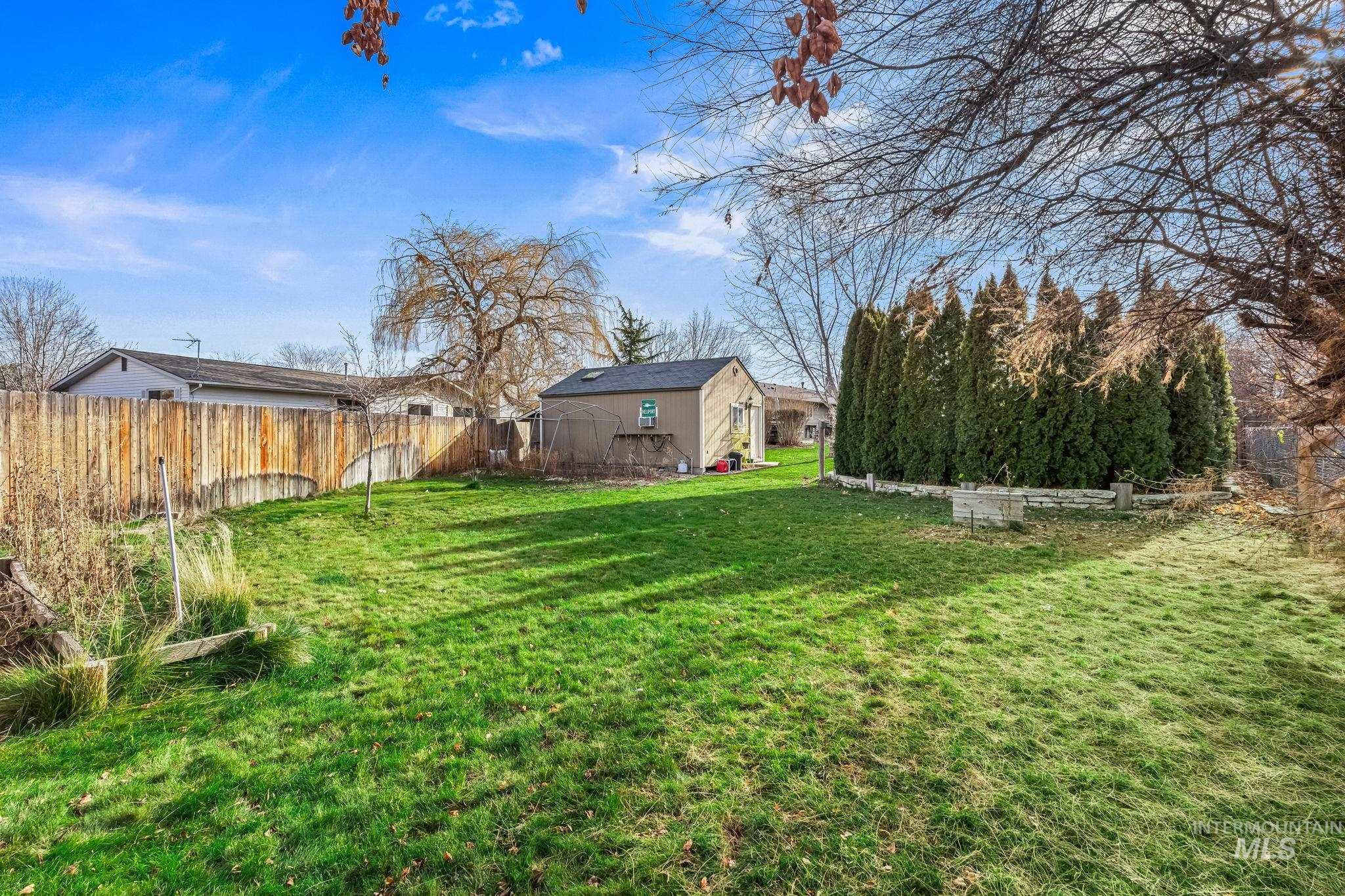 7650 West Colt Drive Boise, ID 83709 - Photo 27 of 30 Fenced backyard with an outdoor structure