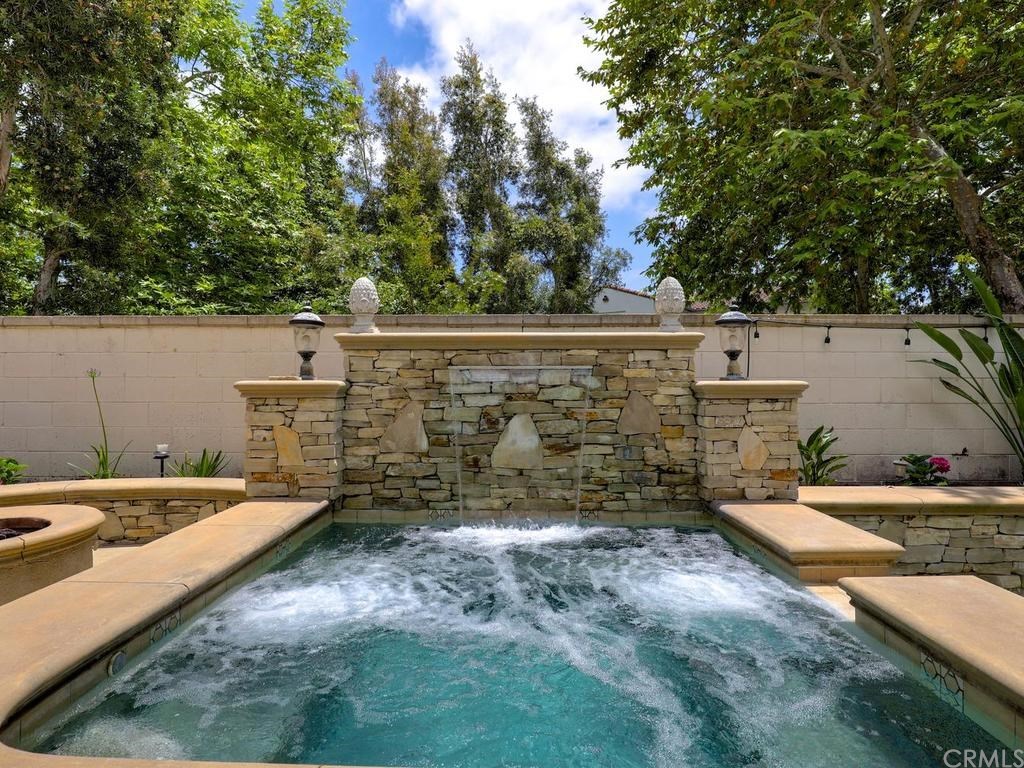 Beautiful spa with waterfall overlooking pool.