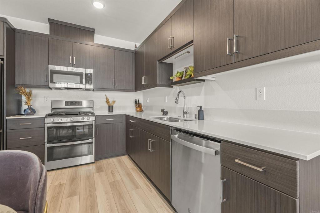 35173 Grove Trail Fallbrook, CA 92028 - Photo 13 of 30 a kitchen with cabinets stainless steel appliances and a sink