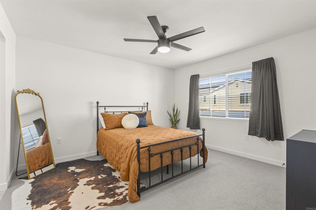 35173 Grove Trail Fallbrook, CA 92028 - Photo 15 of 30 a bedroom with a bed a mirror and a window