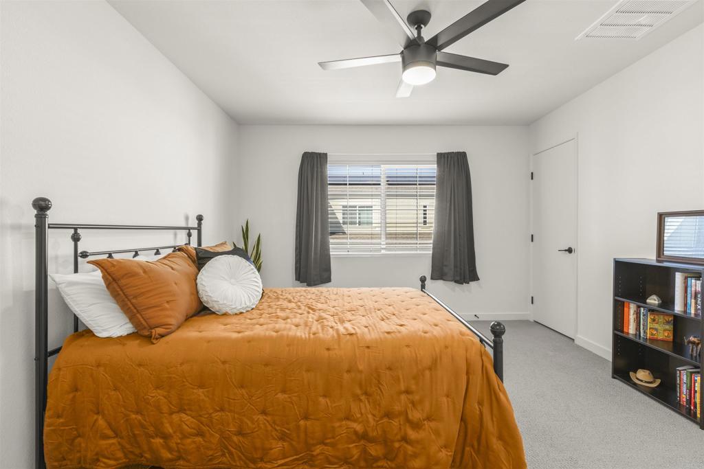 35173 Grove Trail Fallbrook, CA 92028 - Photo 17 of 30 a bedroom with a bed flat screen tv and a window