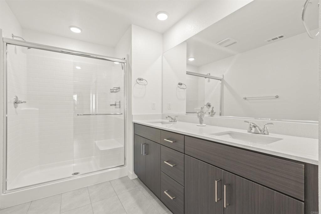 35173 Grove Trail Fallbrook, CA 92028 - Photo 18 of 30 a bathroom with a double vanity sink mirror and shower