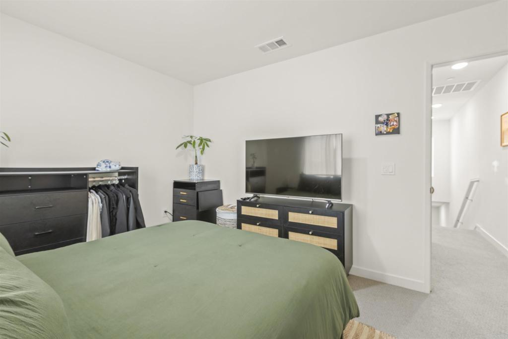 35173 Grove Trail Fallbrook, CA 92028 - Photo 21 of 30 a bedroom with a bed and a flat screen tv