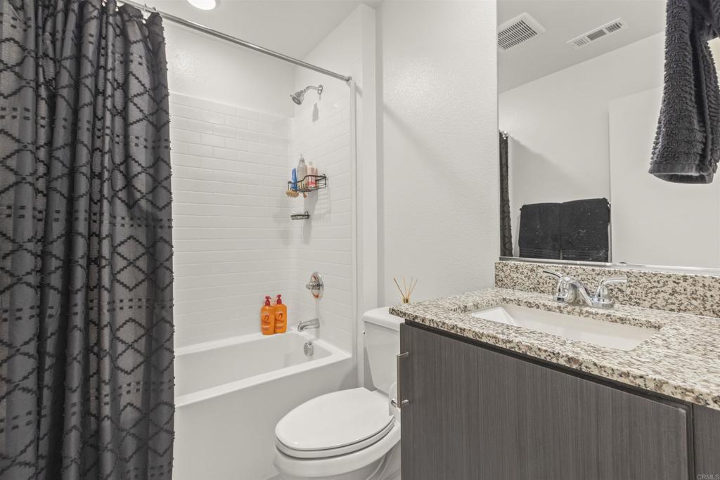 35173 Grove Trail Fallbrook, CA 92028 - Photo 22 of 30 a bathroom with a granite countertop sink toilet and shower