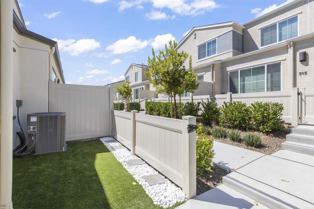 35173 Grove Trail Fallbrook, CA 92028 - Photo 5 of 30 a view of a white house with a small yard and potted plants