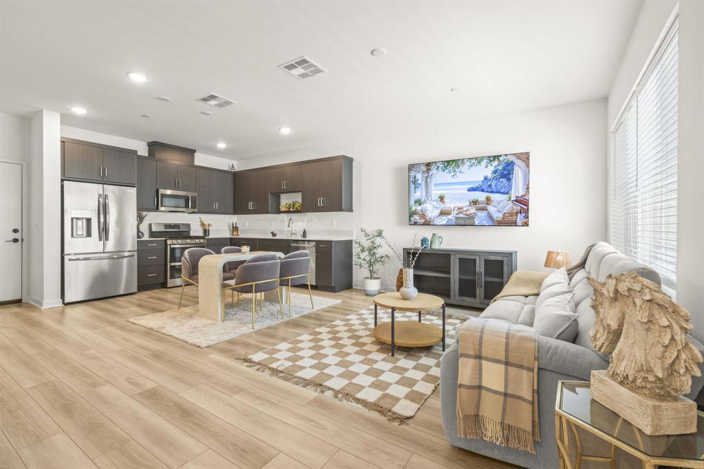 35173 Grove Trail Fallbrook, CA 92028 - Photo 6 of 30 a living room with furniture a fireplace and a flat screen tv