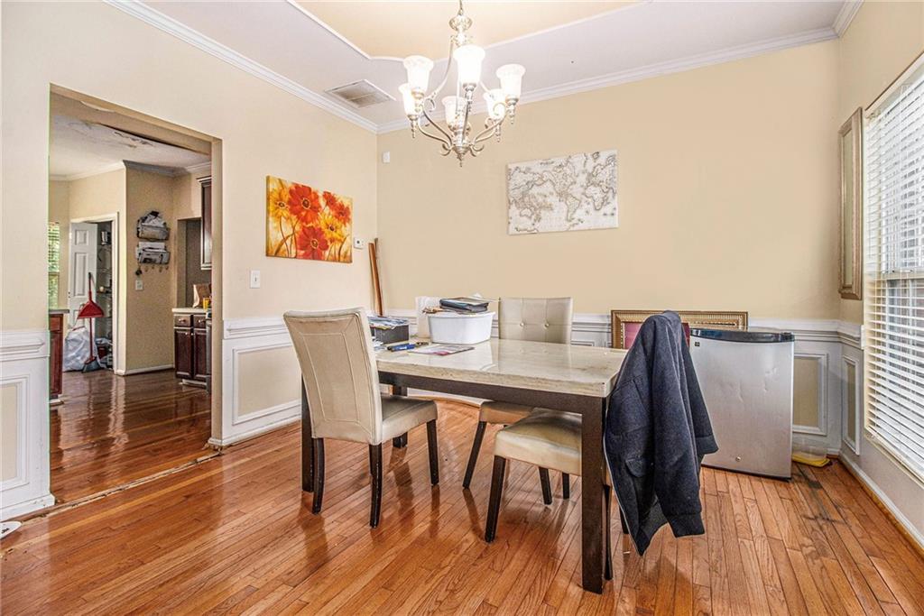 474 Boxelder Road Atlanta, GA 30349 - Photo 11 of 25 a view of a dining room with furniture wooden floor and chandelier