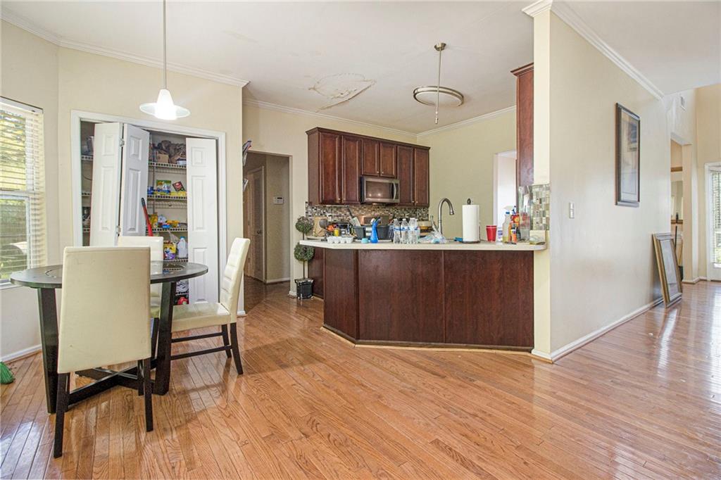 474 Boxelder Road Atlanta, GA 30349 - Photo 12 of 25 a view of a dining room with furniture and a wooden floor