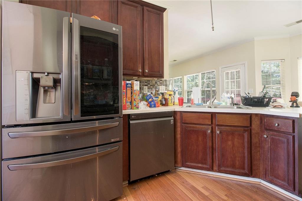 474 Boxelder Road Atlanta, GA 30349 - Photo 14 of 25 a kitchen with stainless steel appliances granite countertop a refrigerator and a sink