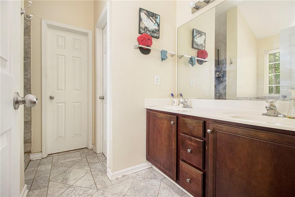 474 Boxelder Road Atlanta, GA 30349 - Photo 18 of 25 a bathroom with a sink vanity and a mirror