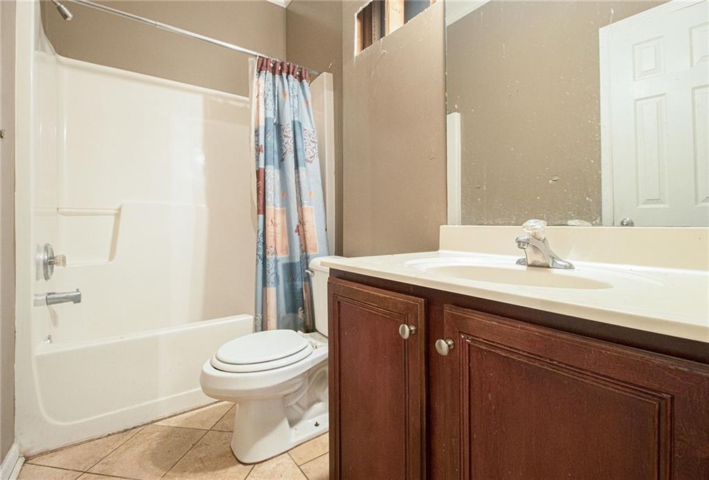 474 Boxelder Road Atlanta, GA 30349 - Photo 19 of 25 a bathroom with a sink toilet and shower