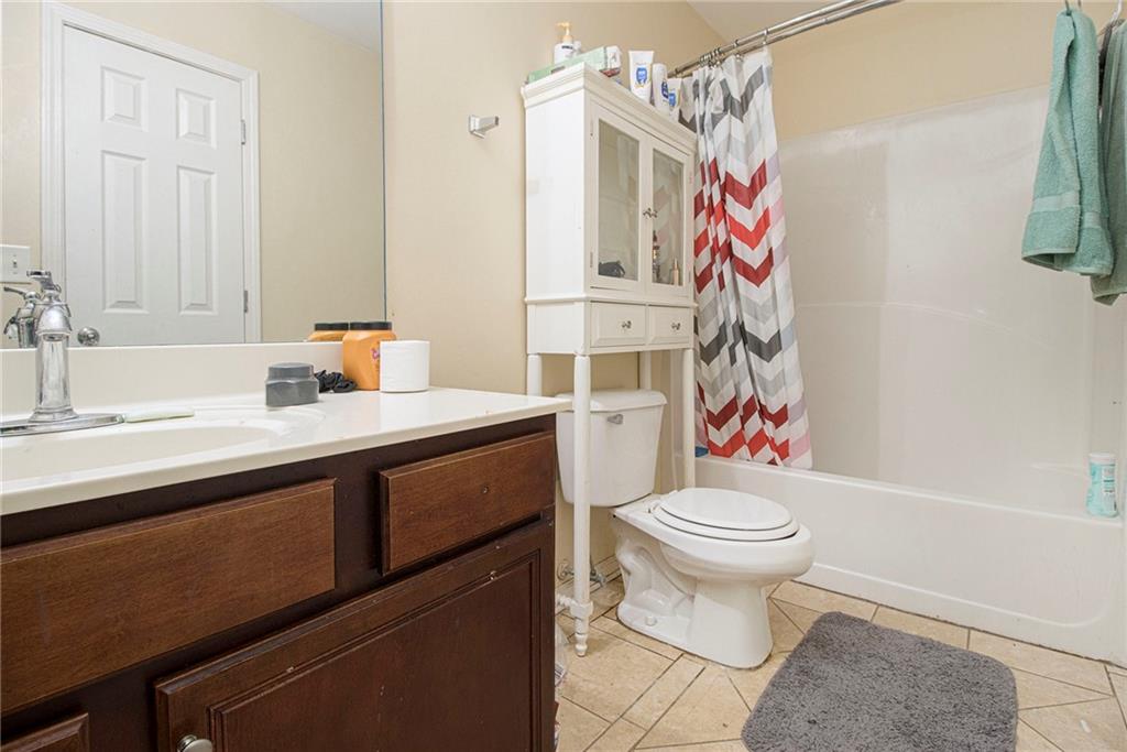 474 Boxelder Road Atlanta, GA 30349 - Photo 21 of 25 a bathroom with a sink toilet and shower