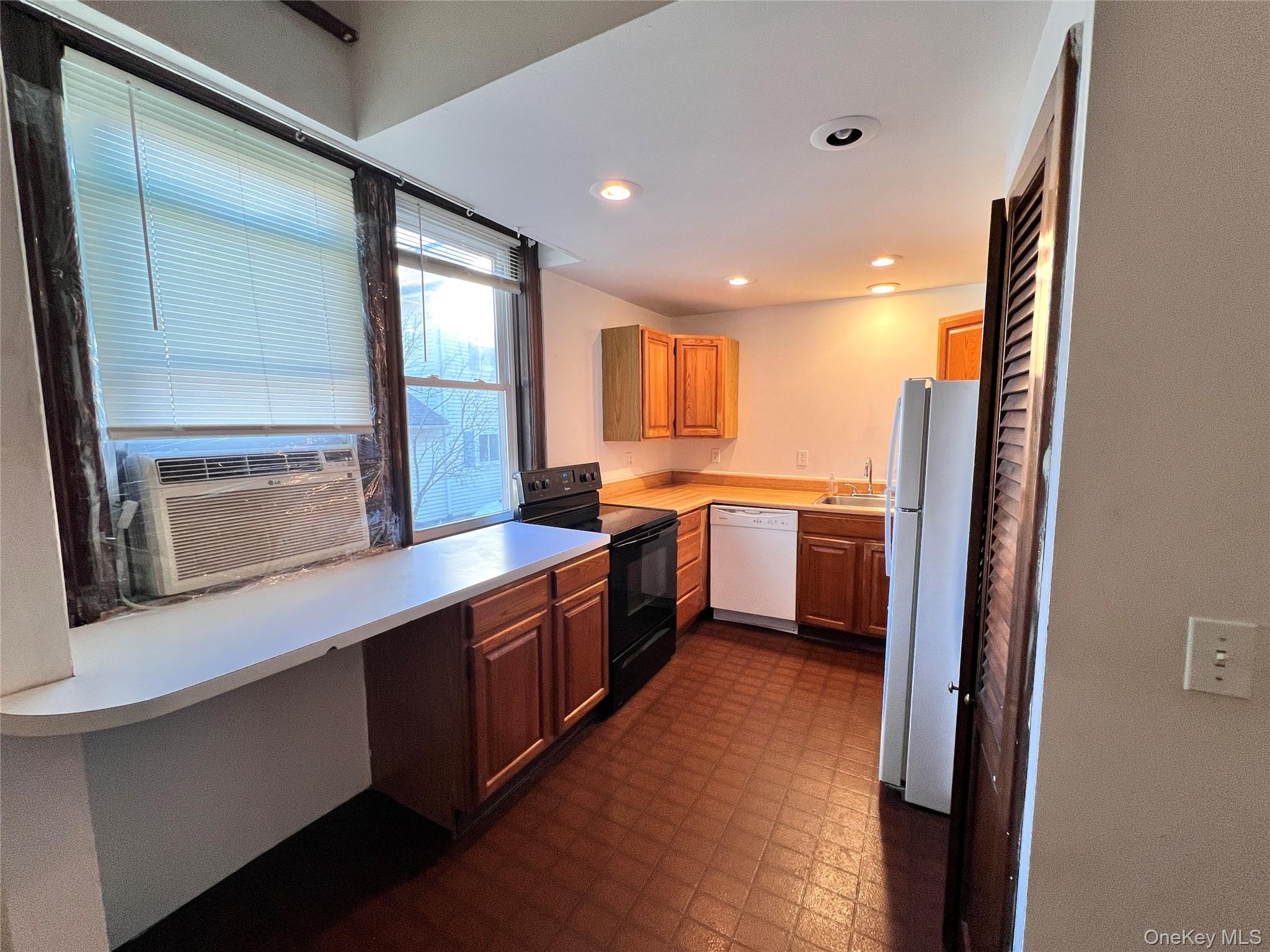 12 Bridge Cornwall, NY 12518 - Photo 5 of 11 a kitchen with stainless steel appliances granite countertop a sink a stove and a refrigerator