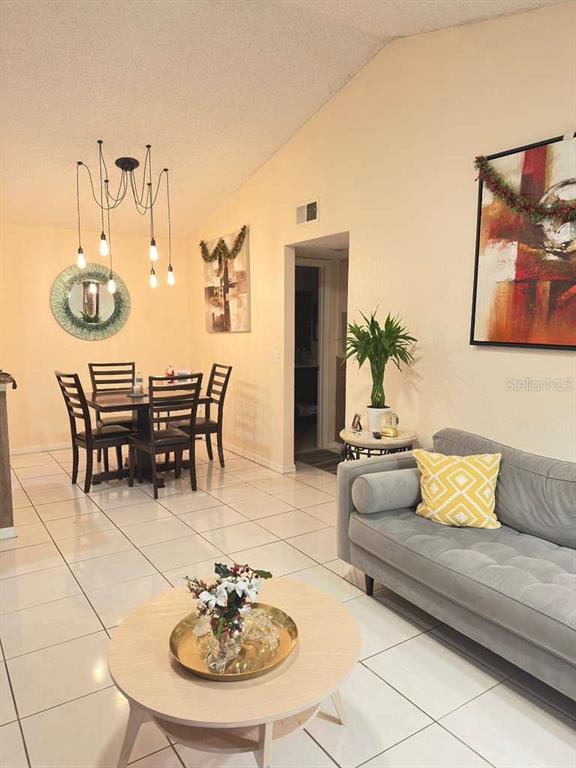 5100 Conroy Road, Unit 26 Orlando, FL 32811 - Photo 4 of 10 a living room with furniture a rug and white walls