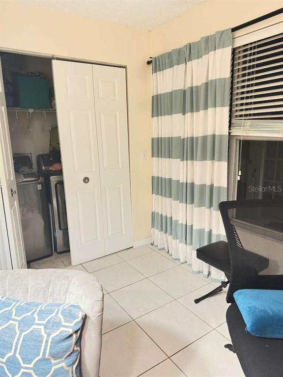 5100 Conroy Road, Unit 26 Orlando, FL 32811 - Photo 6 of 10 a bedroom with a bed and a window