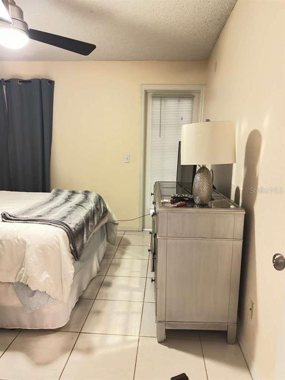 5100 Conroy Road, Unit 26 Orlando, FL 32811 - Photo 7 of 10 a bedroom with a bed and couch