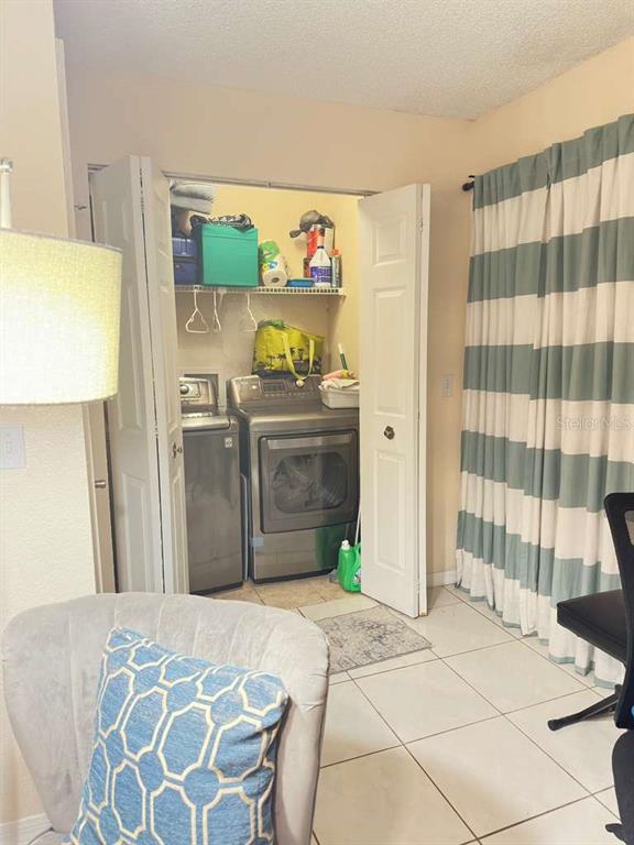 5100 Conroy Road, Unit 26 Orlando, FL 32811 - Photo 8 of 10 a bedroom with a bed and wooden floor