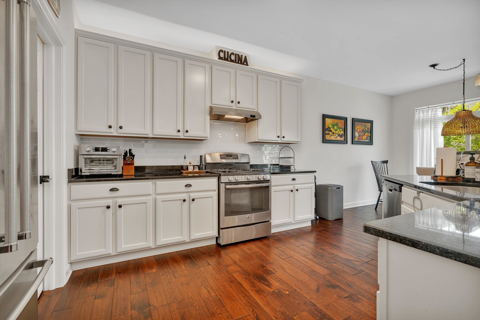 333 Bennett Drive Carol Stream, IL 60188 - Photo 7 of 22 a kitchen with stainless steel appliances white cabinets and wooden floors