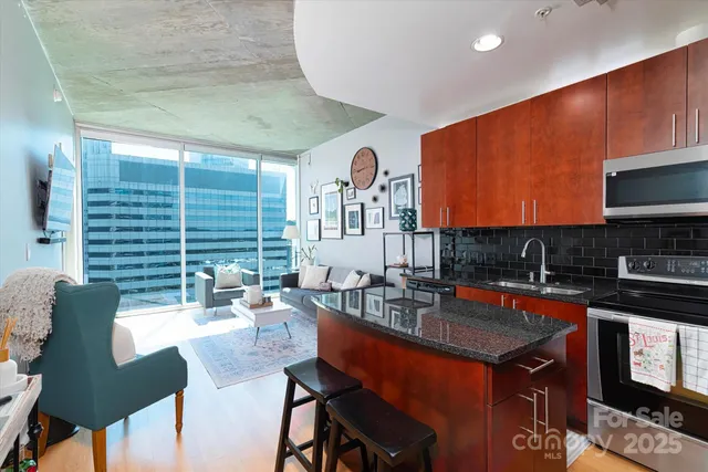a kitchen with a table chairs stove and cabinets