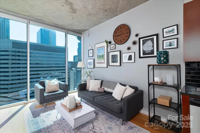 a living room with furniture a rug and a window